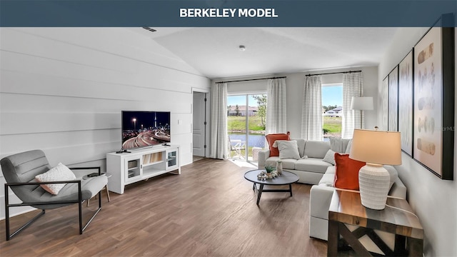 living area featuring lofted ceiling and wood finished floors