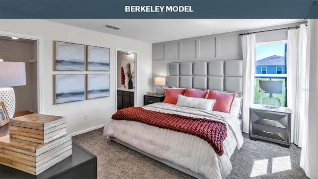 bedroom featuring carpet floors, visible vents, and ensuite bathroom