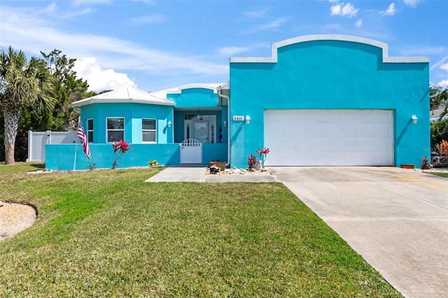 view of front of home featuring a fenced front yard, stucco siding, an attached garage, metal roof, and driveway