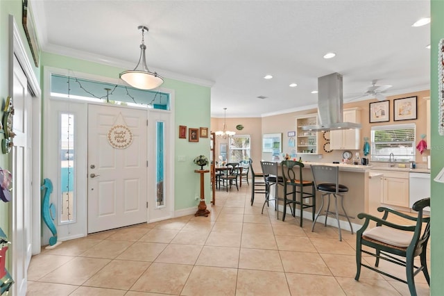 foyer with ceiling fan with notable chandelier, recessed lighting, crown molding, light tile patterned floors, and baseboards