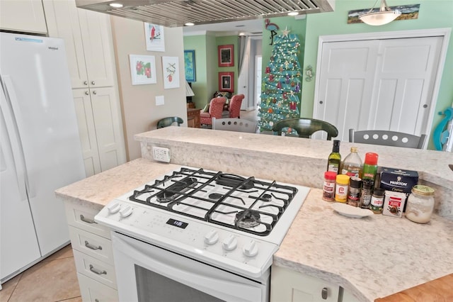 kitchen featuring light tile patterned floors, white appliances, and white cabinetry