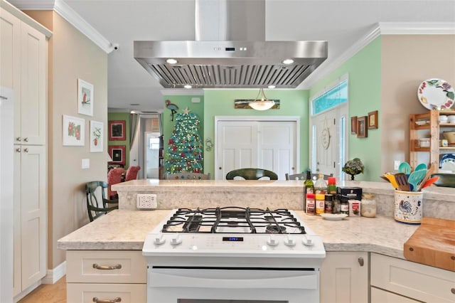 kitchen with range hood, white cabinetry, gas range gas stove, and ornamental molding