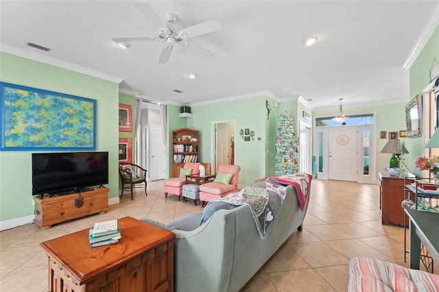 living room with light tile patterned floors, visible vents, ornamental molding, and a ceiling fan