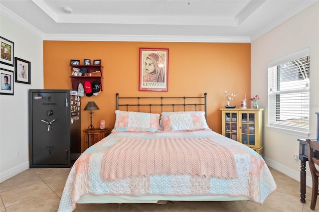bedroom with a tray ceiling, baseboards, crown molding, and tile patterned flooring