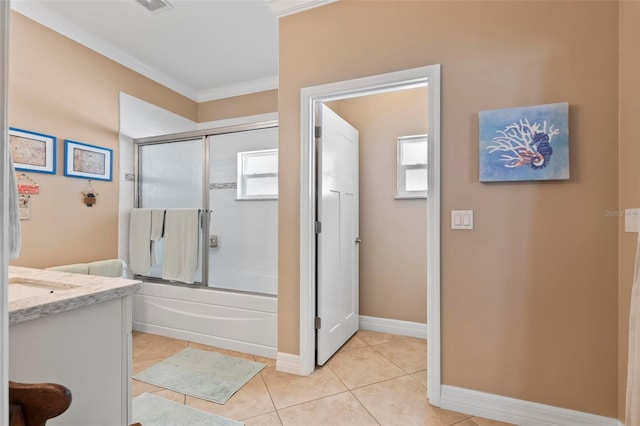 bathroom featuring crown molding, baseboards, tile patterned floors, vanity, and enclosed tub / shower combo