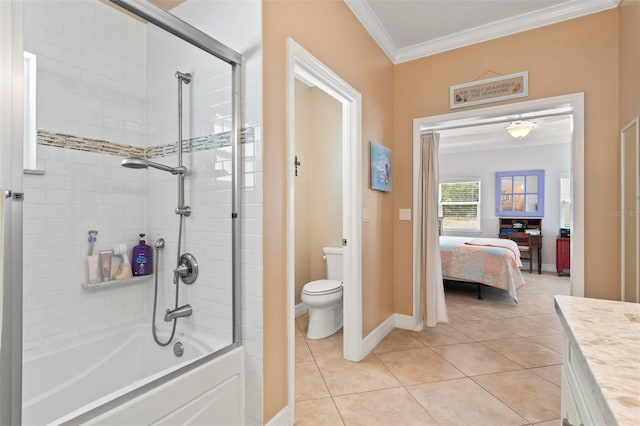bathroom with toilet, washtub / shower combination, crown molding, baseboards, and tile patterned flooring