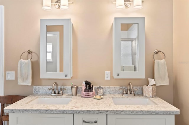 bathroom with double vanity, a notable chandelier, and a sink
