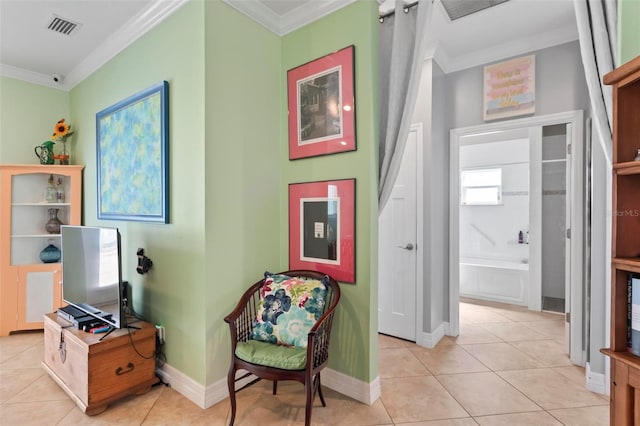 living area with light tile patterned floors, visible vents, and ornamental molding