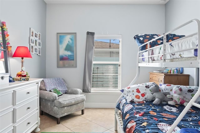 bedroom with light tile patterned floors and baseboards