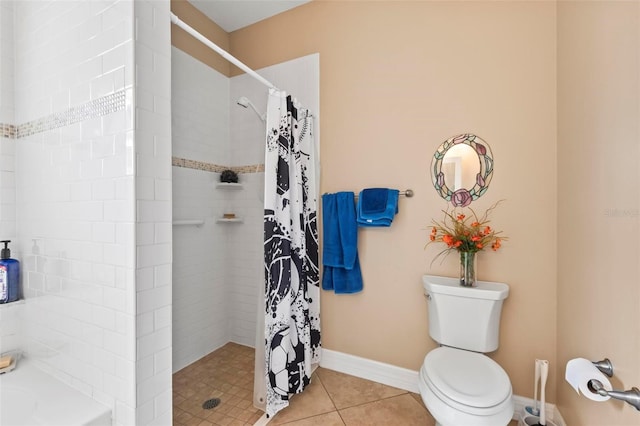 full bathroom featuring baseboards, toilet, tile patterned flooring, and a tile shower