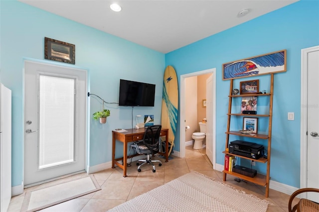 home office with light tile patterned floors and baseboards
