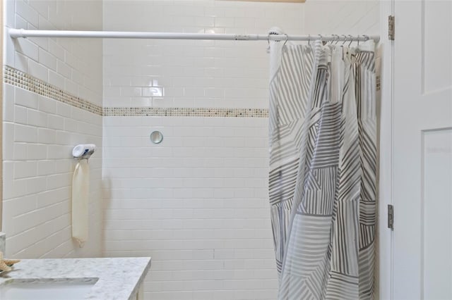 bathroom featuring vanity and a tile shower