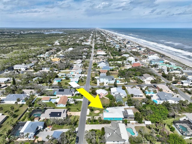 bird's eye view with a water view and a view of the beach