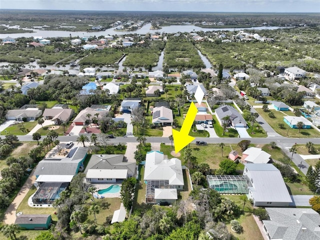 drone / aerial view with a water view and a residential view
