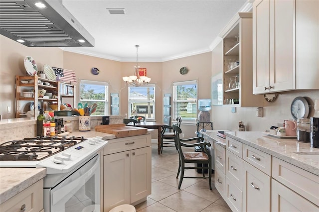 kitchen with range hood, light tile patterned floors, white range with gas stovetop, crown molding, and a notable chandelier