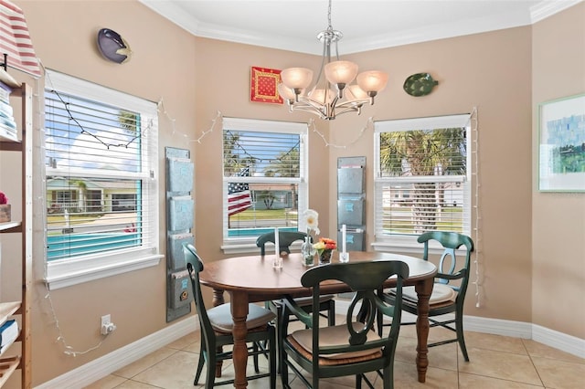 dining area featuring crown molding, light tile patterned floors, baseboards, and a chandelier