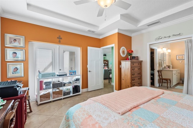 bedroom featuring light tile patterned flooring, visible vents, a ceiling fan, and a tray ceiling