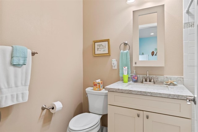 bathroom with toilet and vanity