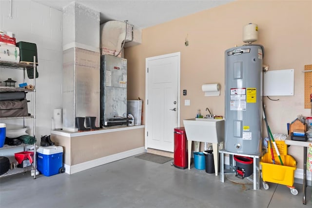 garage featuring baseboards and electric water heater