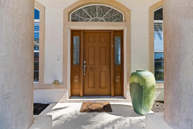 entrance to property with stucco siding