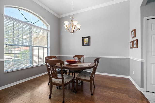 dining space featuring a notable chandelier, baseboards, ornamental molding, and wood finished floors