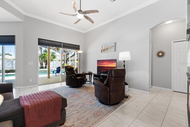 living room featuring light tile patterned floors, baseboards, a sunroom, and crown molding