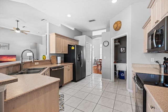 kitchen with light countertops, a ceiling fan, light brown cabinets, a sink, and black appliances