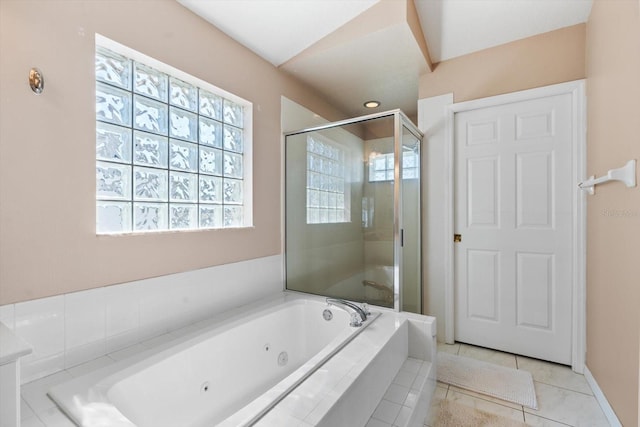 full bath with a stall shower, tile patterned flooring, and a whirlpool tub