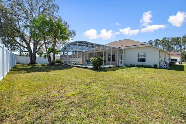 view of yard with a lanai and a fenced backyard