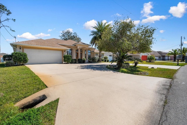 view of front of property featuring a garage, concrete driveway, a front yard, and stucco siding