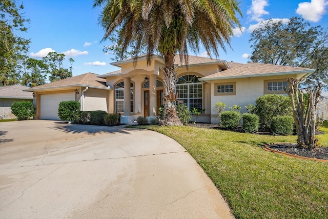 mediterranean / spanish-style house with a front lawn, concrete driveway, an attached garage, and stucco siding