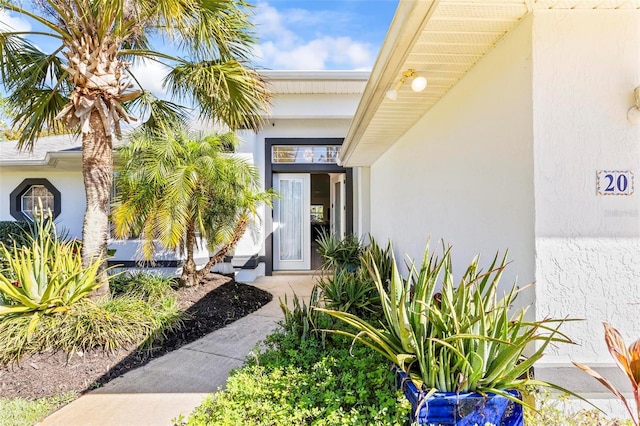 property entrance featuring stucco siding