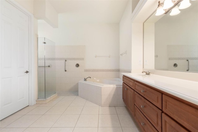 bathroom featuring tile patterned flooring, a garden tub, vanity, and a stall shower