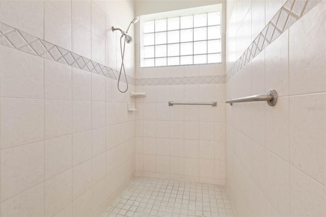 full bath featuring tiled shower