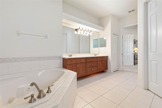 full bath with visible vents, a sink, a jetted tub, tile patterned flooring, and double vanity