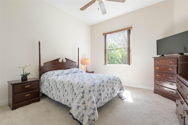 bedroom with light carpet, a ceiling fan, and baseboards