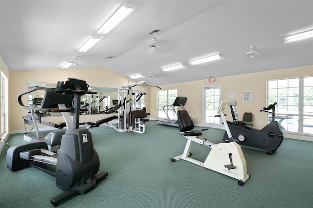 exercise room with visible vents, baseboards, and lofted ceiling