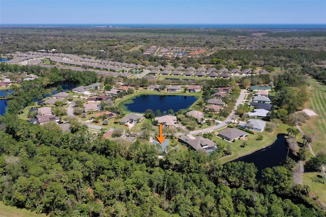 drone / aerial view featuring a residential view and a water view