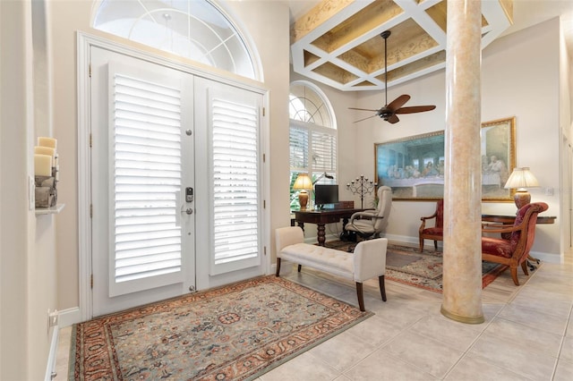 sunroom / solarium featuring ceiling fan, coffered ceiling, and beamed ceiling