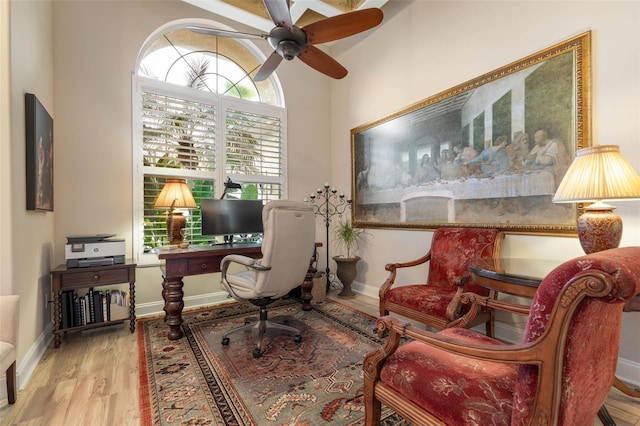 office space with a ceiling fan, baseboards, and wood finished floors