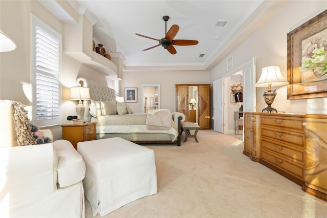 bedroom featuring light carpet, visible vents, connected bathroom, ceiling fan, and crown molding