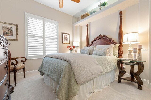 carpeted bedroom featuring a ceiling fan and baseboards