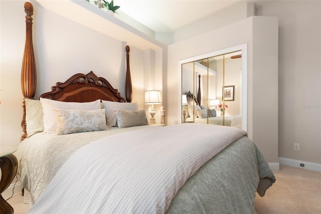 bedroom featuring a closet, baseboards, and carpet flooring