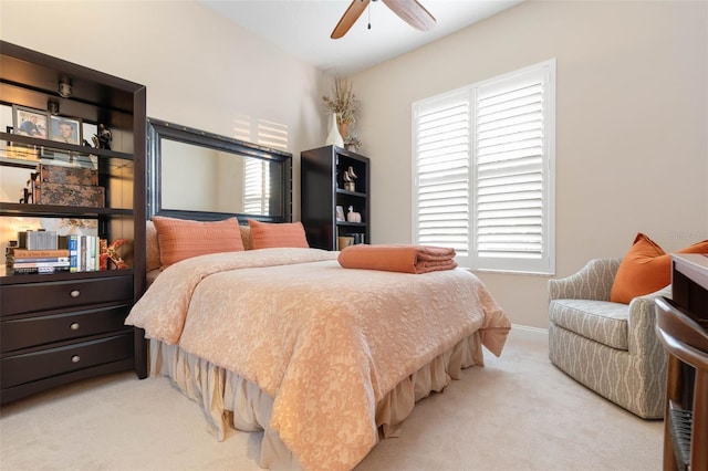 bedroom with ceiling fan, multiple windows, and carpet flooring