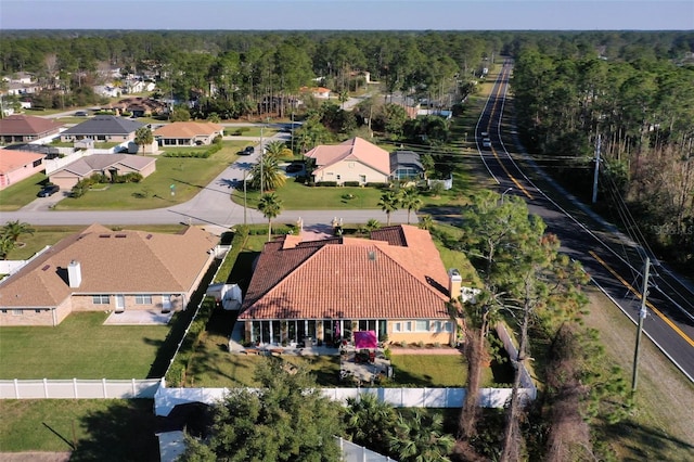 drone / aerial view featuring a forest view and a residential view