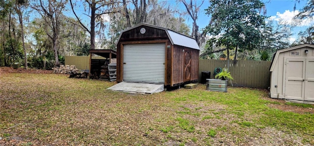 view of shed featuring fence