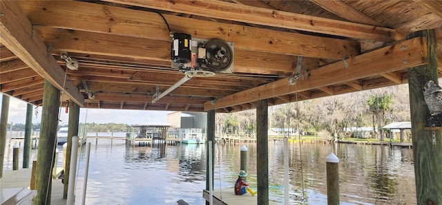 dock area with a water view and boat lift