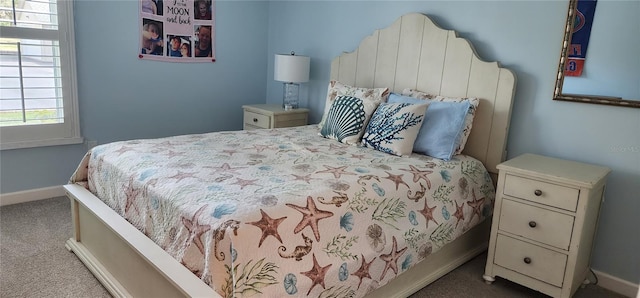 bedroom with carpet flooring and baseboards