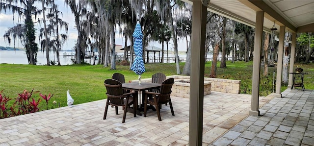 view of patio featuring a water view and outdoor dining space