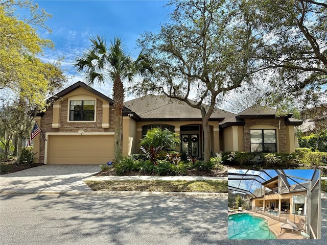 view of front of property featuring an attached garage, french doors, decorative driveway, an outdoor pool, and stucco siding